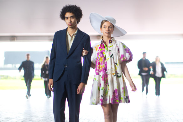 Our tip for general admission on Oaks Day: Model Jack Chettra in a Christian Kimber suit and polo shirt and Lochie Barnett in an Aje dress and Morgan & Taylor hat. 