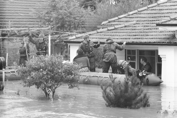 Soldiers rescue a family in Navigator Street, Maribyrnong.