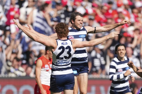 Isaac Smith celebrates a goal with Gary Rohan.