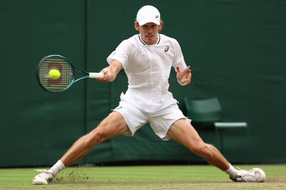 Alex de Minaur slides on the grass during his match against Arthur Fils.