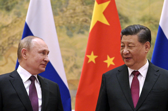 Chinese President Xi Jinping, right, and Russian President Vladimir Putin looks towards each other during their meeting in Beijing in February. While China urges caution, its social media outlets push for outright denial.