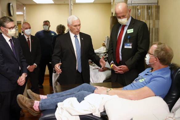 US Vice-President Mike Pence, centre, visits a patient who survived the coronavirus and was going to give blood, during a tour of the Mayo Clinic this week.