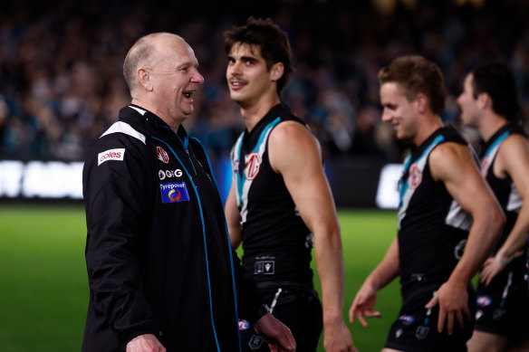 Port Adelaide coach Ken Hinkley exchanging words with Hawthorn players after the match.