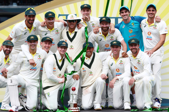 The Australian team poses with the trophy.