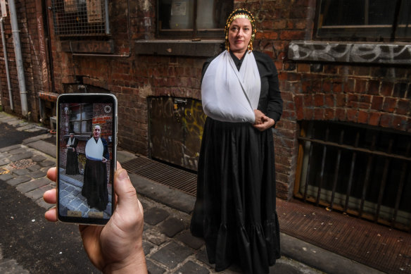 Emma Ramsay, co-creator of the Eastern Market Murder mobile phone app, in period costume at a key location from the case, and the game.