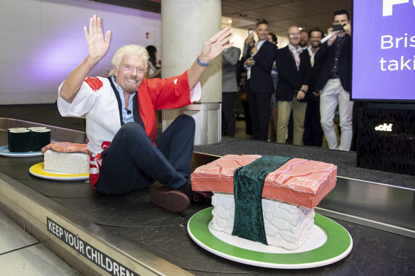Sir Richard Branson, founder of Virgin Group arrives on a giant sushi train. Brisbane Tokyo flights announcements at Brisbane Airport