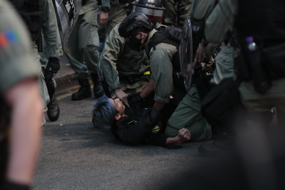 Police arrest a protester in Hong Kong on Sunday.