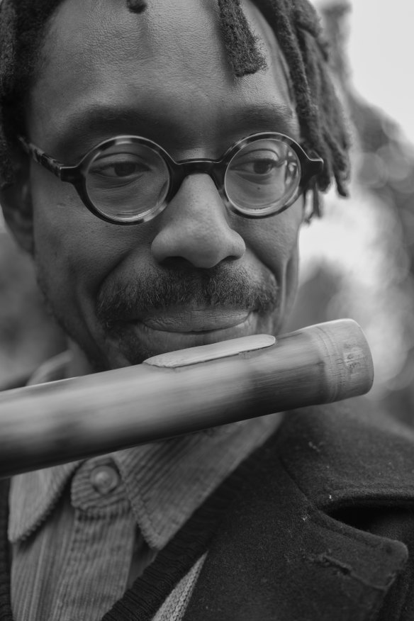 Shabaka playing a shakuhachi, a Japanese bamboo flute.
