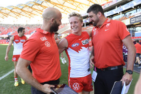 Swans star Isaac Heeney with assistants Jarrad McVeigh and Dean Cox.