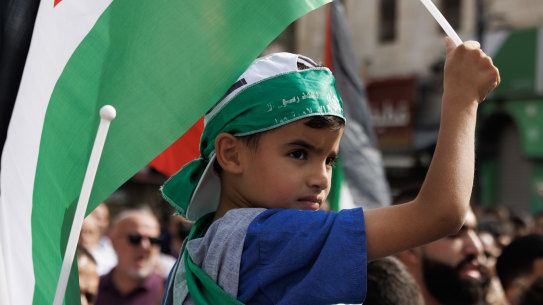 Hamas is not a fringe movement but has popular support  among Palestinians. A boy wearing a Hamas headband holds a Palestinian flag as protesters gather in Ramallah, West Bank. 