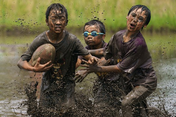 Participants play rugby in a muddy rice field in Fujimi, Saitama Prefecture, Japan. Teams competed in the event, with the winner determined by the combined scores of all matches. Four-player rugby matches held in rice fields before the planting season have been gaining popularity in Japan as a form of community engagement and regional revitalisation.