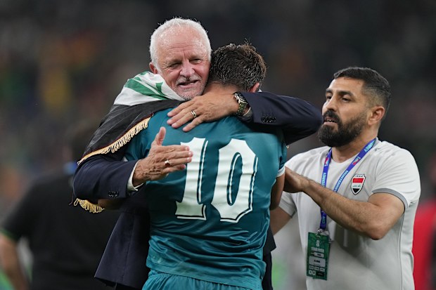 Graham Arnold celebrates with Mohanad Ali (10) after Iraq’s World Cup play-off victory.
