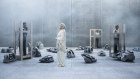 Judith Neilson standing amid artworks by Gu Wenda and Zhou Xiaohu in her storage facility at Dangrove. 