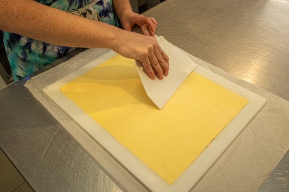 Pressing sheets of butter into the mould.
