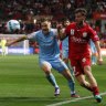Scott Jamieson of Melbourne City and Adelaide’s Lachlan Brook vie for possession.