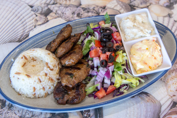 Grilled kofte meal with carrot dip and eggplant dip.