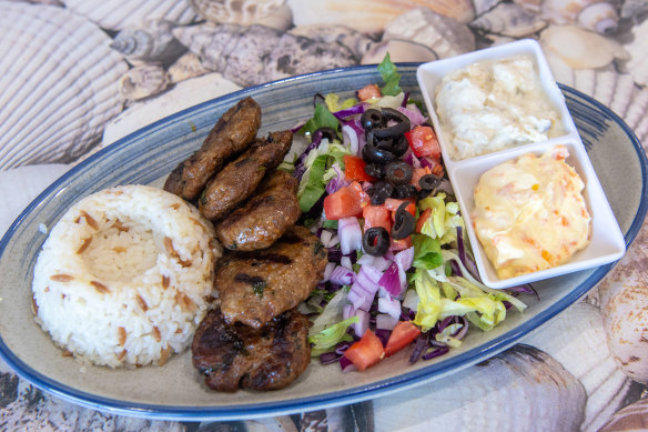 Grilled kofte meal with carrot dip and eggplant dip.