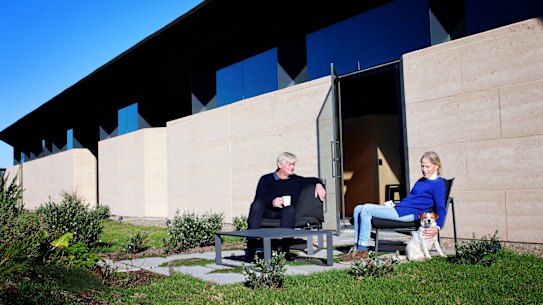 Rob and Sally Hawkins and The Hawkins house at Mystery Bay. The house was a family build. Rob is an architect, but semi retired, and his son Jack, a Sydney architect, designed the house for his parents as clients. The Hawkins family all got together to build and paint the building that is now a finalist in this year’s awards for the AIA’s NSW new house of the year to be announced on July 2. It was also featured on Grand Designs this year. 25th June 2021. Photo: 