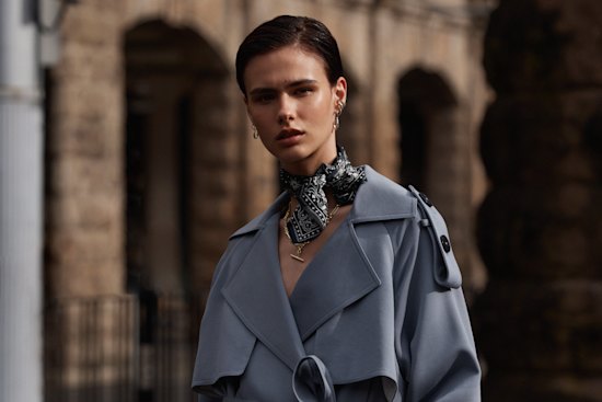 Attire the Studio wool trench coat, $950. Nudie bandanna, $50. Arms of Eve “Duke” gold necklace, $110 (worn throughout). Jasmin Sparrow “Lulu” drop-hoop earrings, 
$329 a pair (worn throughout). Sarah & Sebastian “Bold Liberty” ear cuffs, $280 each (worn throughout).  