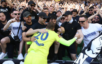 Victory goalkeeper Ivan Kelava celebrates with fans after the 3-0 win at AAMI Park.