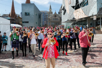 Don Jordan leads the trombone troupe parading into Federation Square on Thursday afternoon,