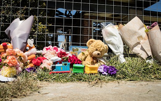 Floral tributes and toys left outside the Werribee home after a fire killed four young siblings.