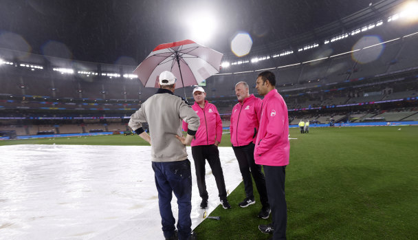 MCG curator Matt Page confers with umpires at the MCG during the washed out game between Australia and England.