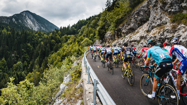 The peloton rides up the Plateau des Glieres in the 2018 Tour de France.