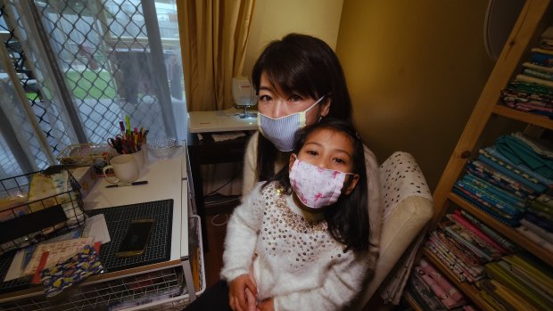 Sayaka Nakamoto with daughter Mira, 5, wearing their face masks at their home in Altona. 