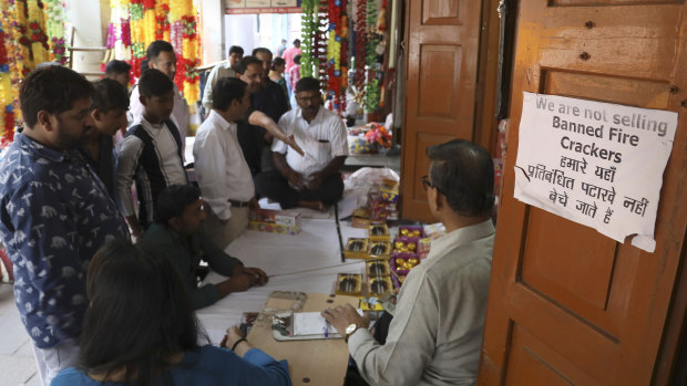 Indians shop for green firecrackers ahead of Diwali festival in New Delhi, India.