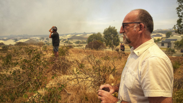 Residents keep watch as the fire approaches. 