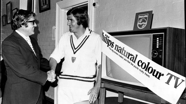 Cricketer Gary Gilmour accepts a colour TV set from Philips consumer manager, Mr Bruce Rowan.
