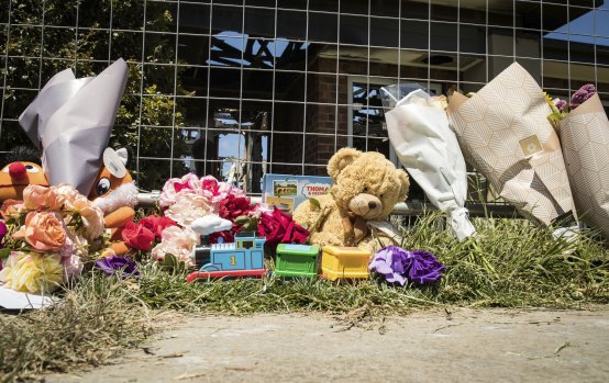 Floral tributes and toys left outside the Werribee home after a fire killed four young siblings.