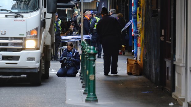 Police investigate in Degraves St, after a sleeping man was run over by a garbage truck.