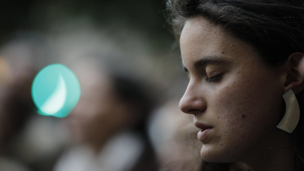 People gather at Saint Sulpice church in Paris before attending a candlelight vigil at Notre Dame Cathedral in Paris.