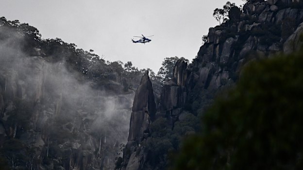A police helicopter flies over Mount Buffalo National Park searching for Dezi Freeman.