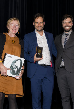 Wrong Skin consulting producer Siobhan McHugh and executive producer Greg Muller accept the award for Podcast of the Year from MC Tom Hogan.