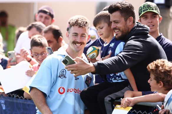 Wallabies halfback Nic White poses with some fans in France.