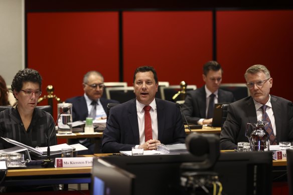 Planning Minister Paul Scully (middle) next to Reconstruction Authority chief executive Simon Draper (right) during budget estimates on Friday.