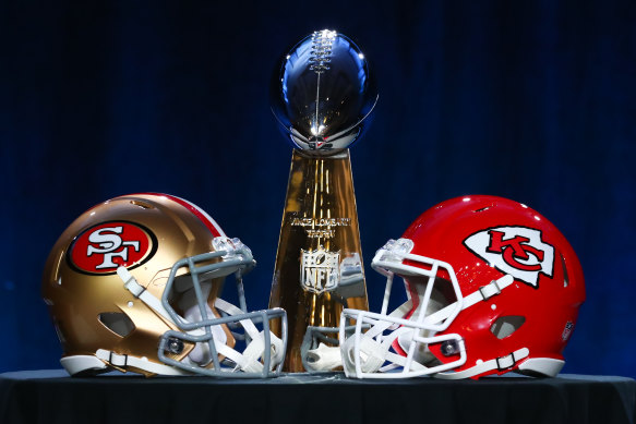 The Vince Lombardi Trophy with San Francisco and Kansas City helmets.
