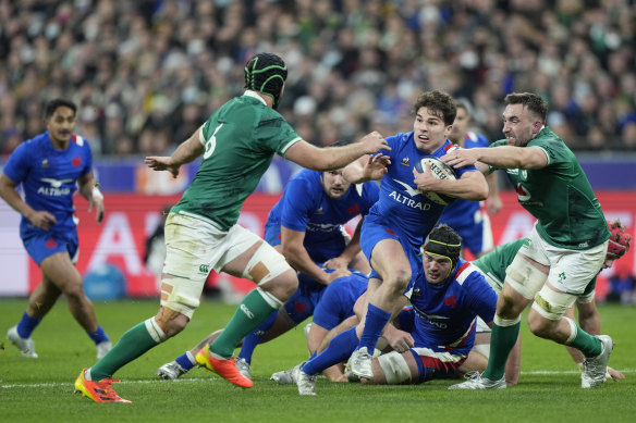 Antoine Dupont takes the ball forward against Ireland.