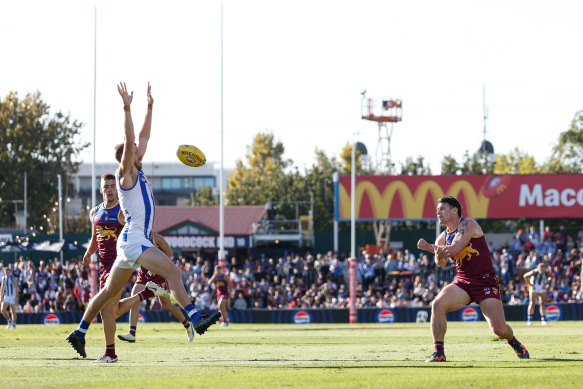 Lachie Neale gets a handball away.