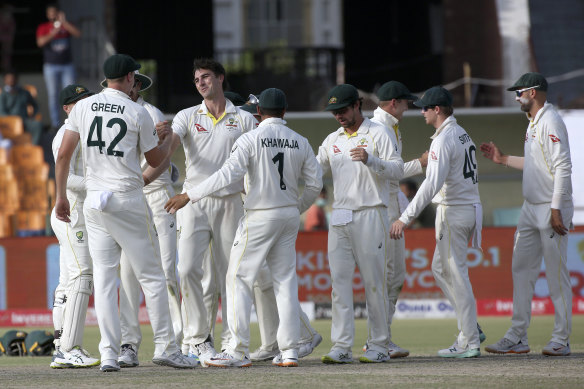 Pat Cummins and his Australian team celebrate winning the third Test against Pakistan.