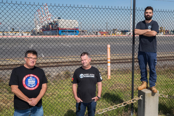 Union officials Shane Stevens, David Ball and Aarin Moon with the Xin Da Lian behind them.