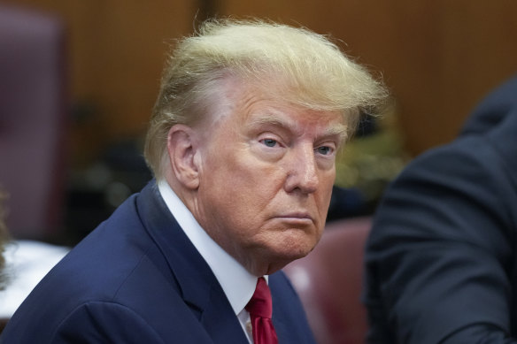 Former president Donald Trump sits at the defence table in court.