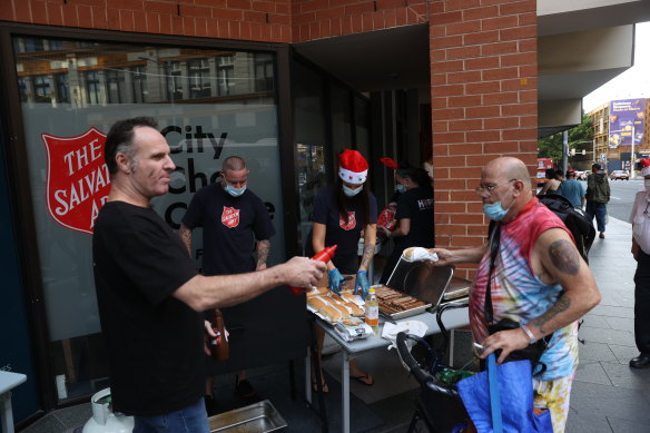 The Salvation Army normally holds a sit down Christmas dinner but due to the coronavirus they are handing food out on the street to those in need at the Sydney Congress Hall.  