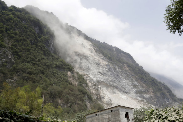 A cloud of dirt follows a mudslide a day after a powerful earthquake struck, in Hualien City, eastern Taiwan.