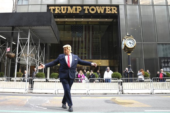 A Donald Trump impersonator directs traffic in front of Trump Tower.