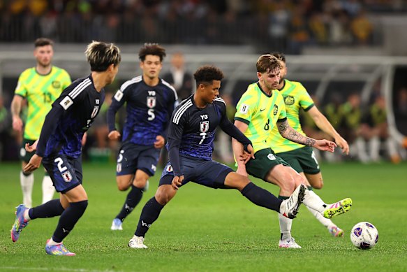 Connor Metcalfe of the Socceroos passes the ball