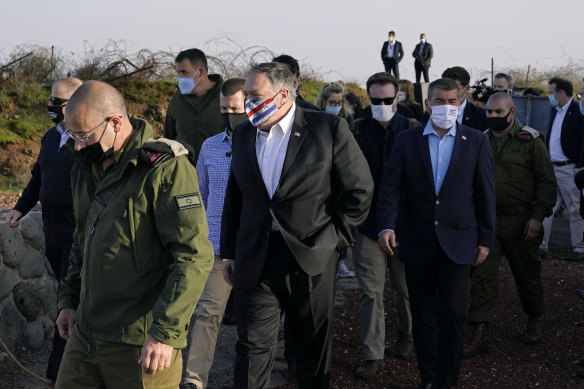 Secretary of State Mike Pompeo, centre, arrives on Mount Bental in the Israeli-controlled Golan Heights.